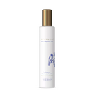 A tall white cylindrical bottle of RITUALS body mist with a metallic gold cap, featuring blue and gold text and a blue illustration on a clean white background.