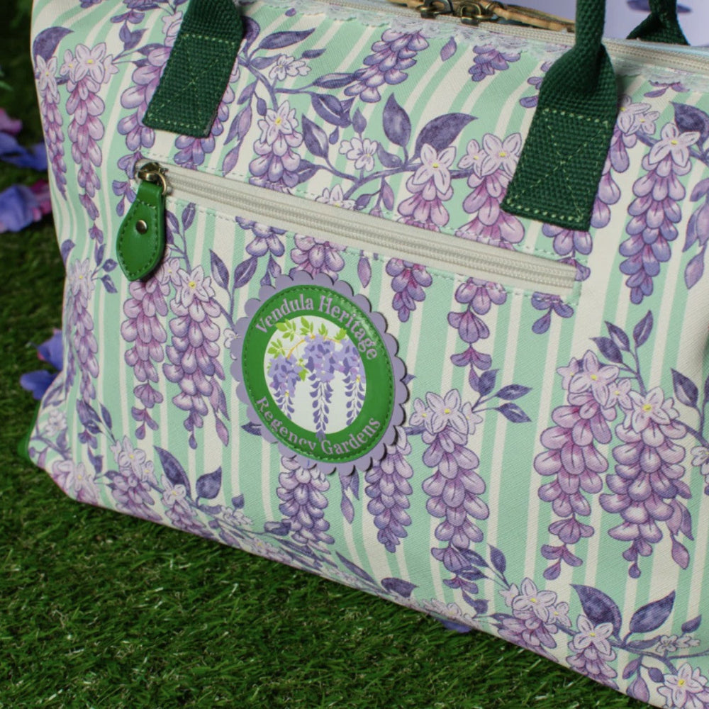 Floral patterned bag with a visible brand logo on a grassy background