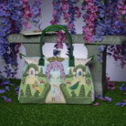 Decorative bag with garden scene design on a stand with floral background