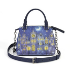 A navy blue handbag featuring a detailed illustration of a night scene with a crescent moon, stars, and glowing yellow windows on a blue-toned building facade. The bag has dark blue leather top handles, a matching adjustable shoulder strap with silver-tone buckle, and silver-tone chain details on the sides.