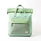 A mint green roll-top backpack with a front zippered pocket.