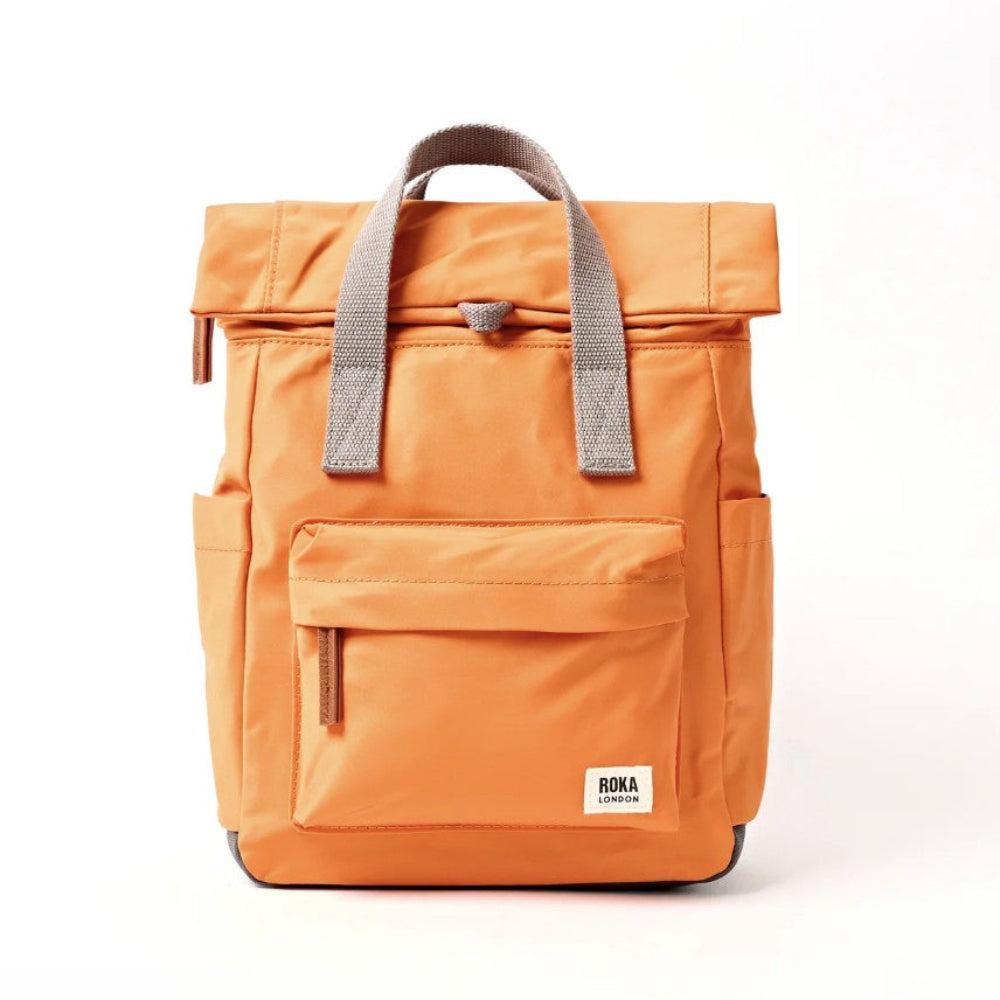 An orange roll-top backpack with grey handles.
