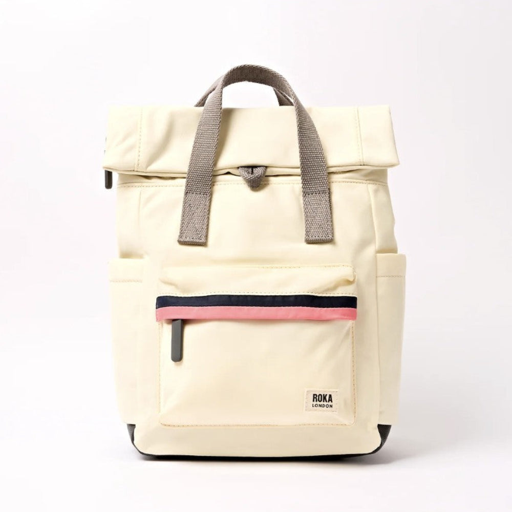 A cream-colored roll-top backpack with grey handles, a front zippered pocket featuring a pink stripe.