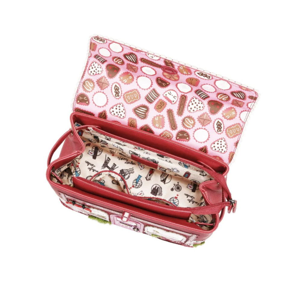 Pink and red handbag with a patterned interior on a white background
