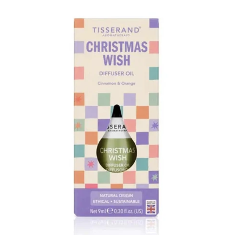 Tisserand Apothecary 'Christmas Wish' diffuser oil in its original packaging, featuring a cream-colored box with a pastel checkerboard pattern and a green glass dropper bottle visible through a cutout.