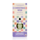 Tisserand Apothecary 'Christmas Wish' diffuser oil in its original packaging, featuring a cream-colored box with a pastel checkerboard pattern and a green glass dropper bottle visible through a cutout.