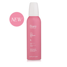 A pink aerosol can of Bare by Vogue Clear Whipped Tan hair product on a white background, with a pink circular 'NEW' badge on the left.