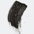 Black cosmetic smear on a light gray background