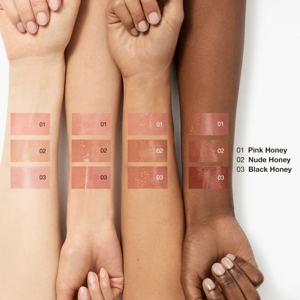 Three hands with different skin tones displaying makeup swatches labeled 'Pink Honey', 'Nude Honey', and 'Black Honey'.