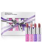 Clinique Kisses lipstick gift set featuring a white box with a purple ribbon and four individual lipsticks in pink, nude, purple, and mauve shades displayed in front.