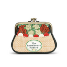 A small kiss-lock purse with a woven straw-like front pocket and a printed vegetable pattern on the flap. The front pocket has a round label reading 'The Farmhouse Pantry'.