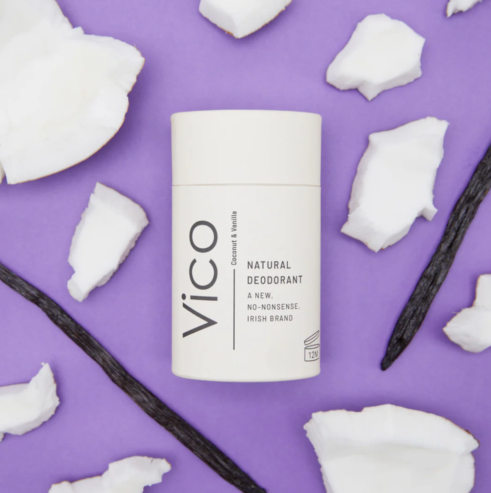 Vico natural deodorant container on a purple background with coconut pieces and vanilla beans.