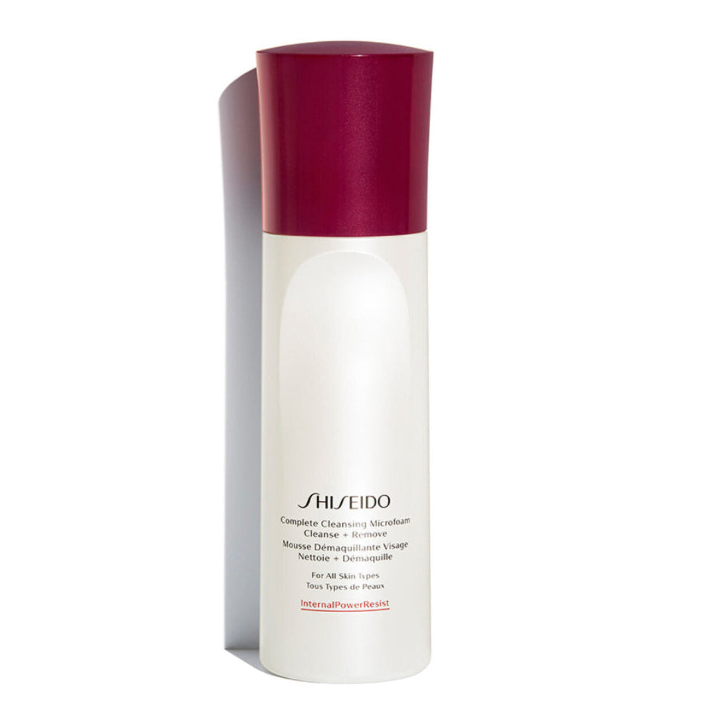 Shiseido bottle with a white body and red cap on a white background