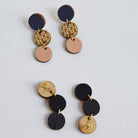 Pair of multicolored circular earrings on a light gray background