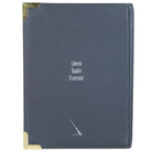 Blue leather-bound book with gold corners and text on a white background