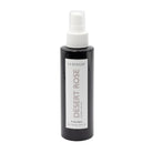 Black bottle of 'Desert Rose' linen spray by La Bougie on a light gray background