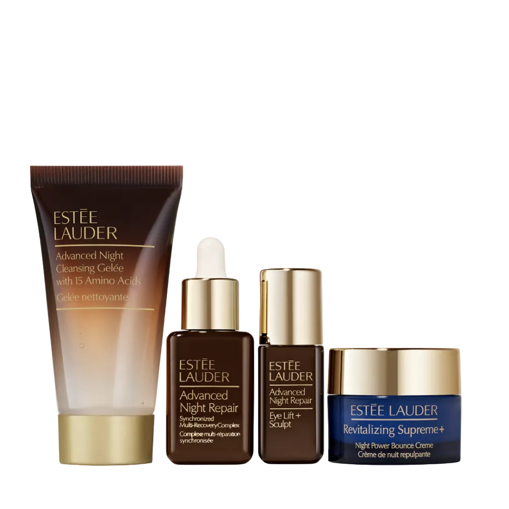 Four Estée Lauder skincare products arranged on a light gray background: a large Advanced Night Cleansing Gel tube, an Advanced Night Repair serum bottle with a dropper, an Advanced Night Eye Lift bottle, and a Revitalizing Supreme+ cream jar.