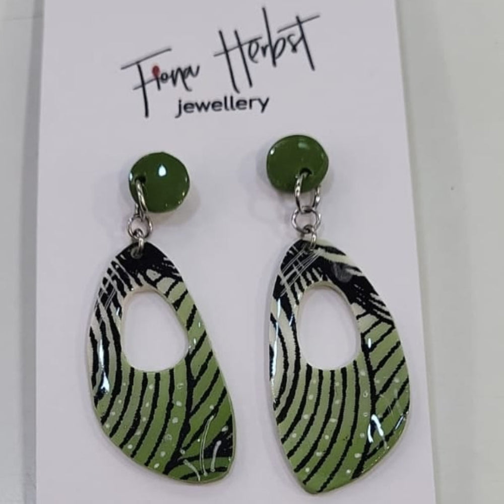 Zebra print earrings on a branded card with a white background
