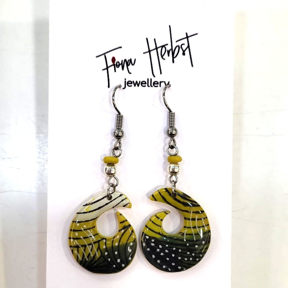 Pair of earrings with black, yellow, and white design on a white background with 'Fiona Herbst Jewellery' branding.