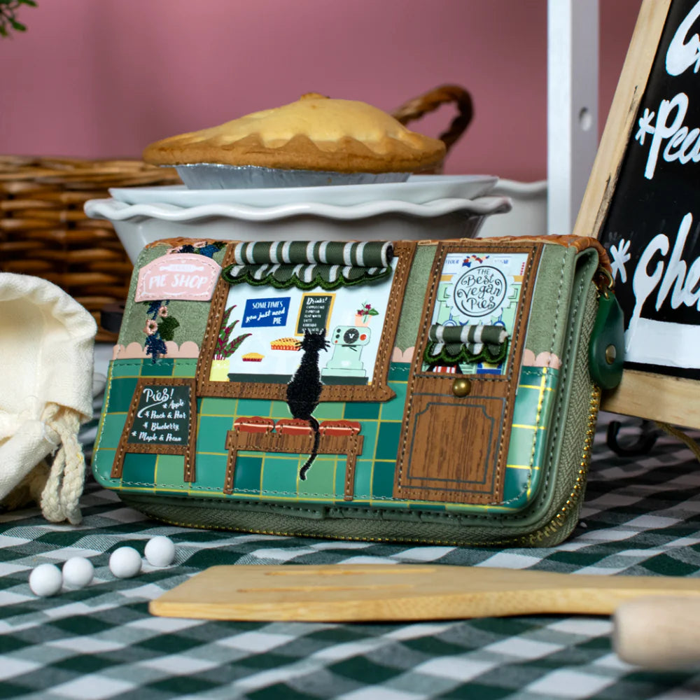 Handbag with a detailed design of a market scene on a checkered tablecloth.