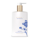 A white bottle of Rituals Dutch Tulip & Yuzu hand wash with a gold pump and blue floral illustrations, set against a plain white background.