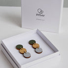 Pair of earrings in a white box with 'Pithy' branding on a light gray background