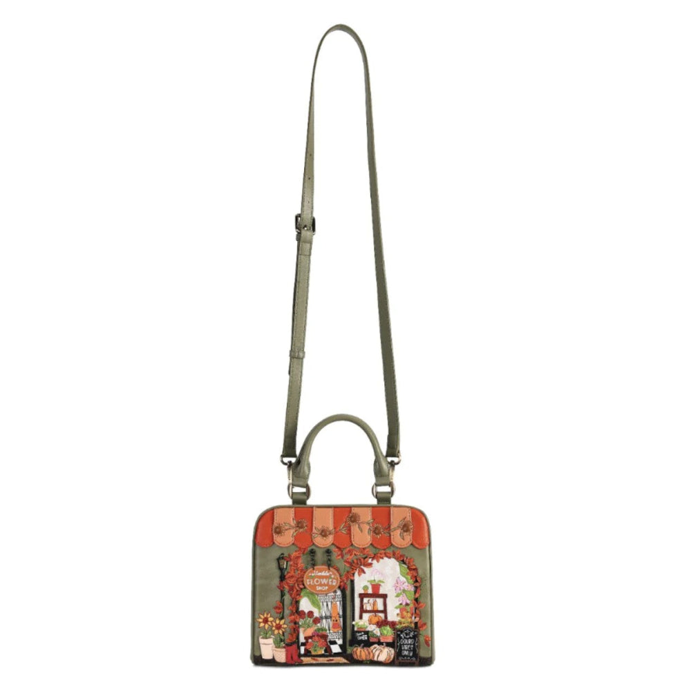 A small rectangular shoulder bag with a long olive green strap and a colorful vintage-style illustrated front panel, shown on a plain white background.
