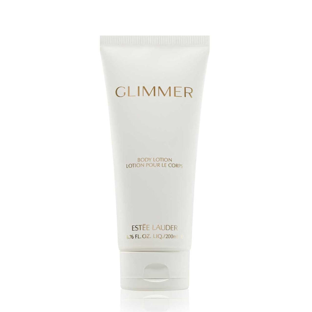 A white squeeze tube of Estée Lauder Glimmer Body Lotion with gold lettering, centered on a clean white background.