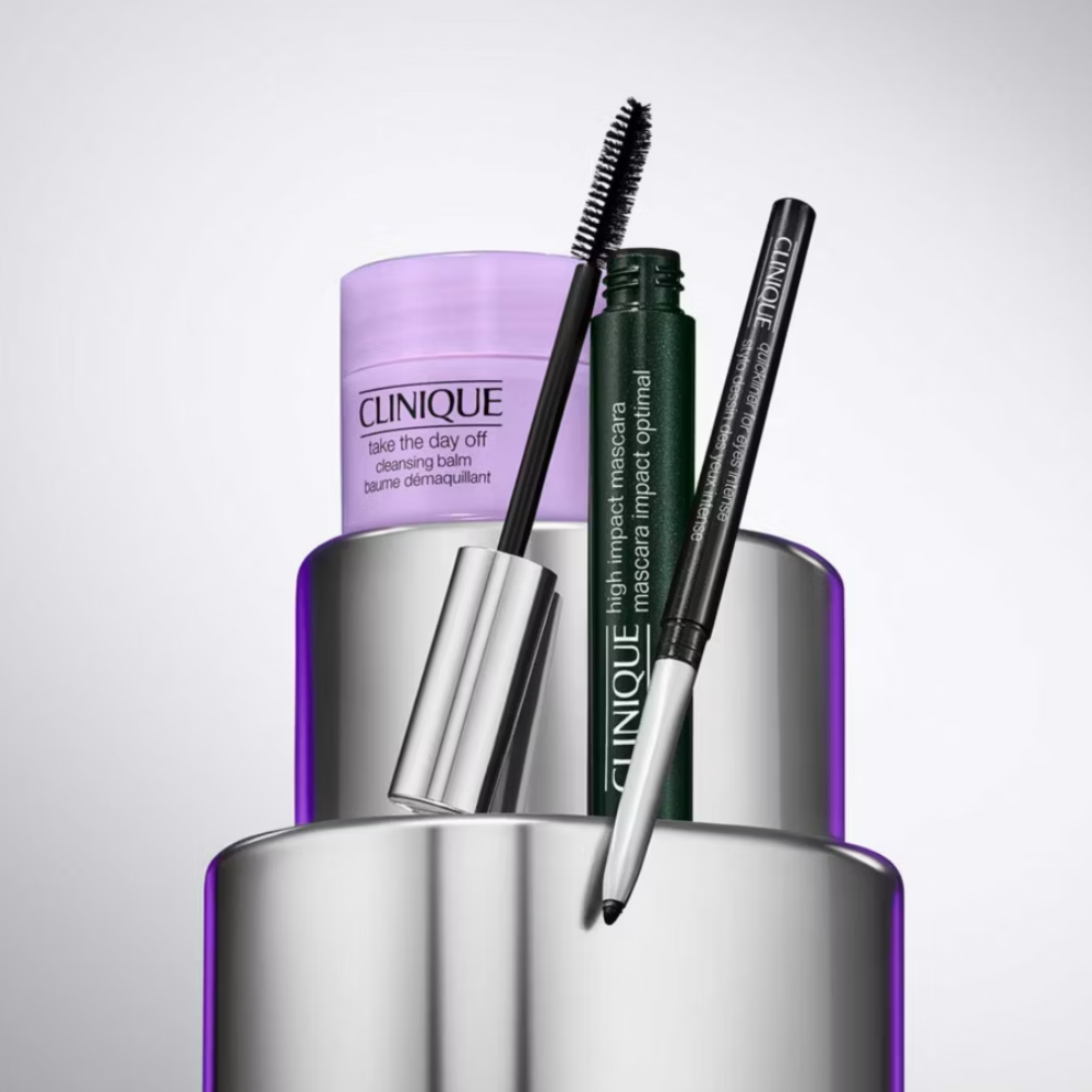Clinique makeup products including a mascara and eyeliner on a reflective surface.