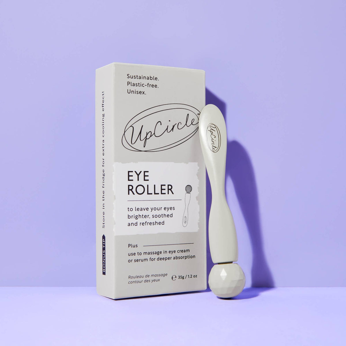 UpCircle eye roller with packaging on a purple background