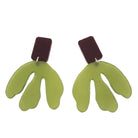Pair of green leaf-shaped earrings with brown tops on a white background