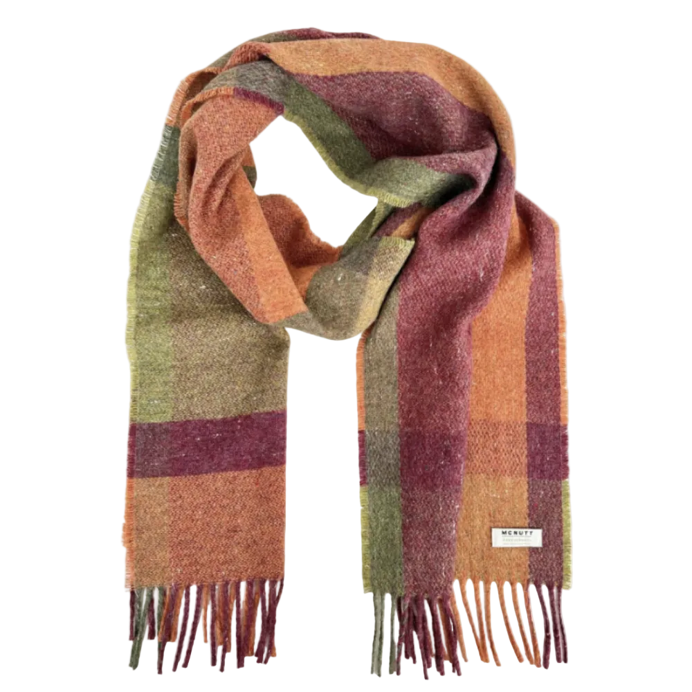 A plaid woven scarf in muted autumn colors including orange, burgundy, olive green, and tan, with fringe ends and a small white brand label reading MINKAY.