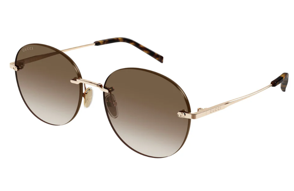 Sunglasses with gold frame and gradient lenses on a white background