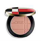 Shiseido Powder Blush Glow Enhancer in a black compact with a gold rim and a lid featuring a red, black, white, and gold checkered pattern, shown open on a white background.