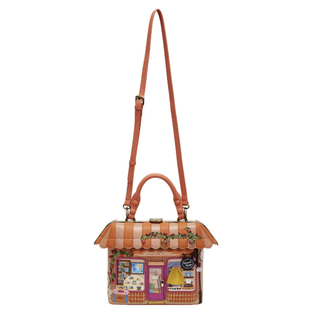 Handbag designed like a small house with a striped roof on a white background