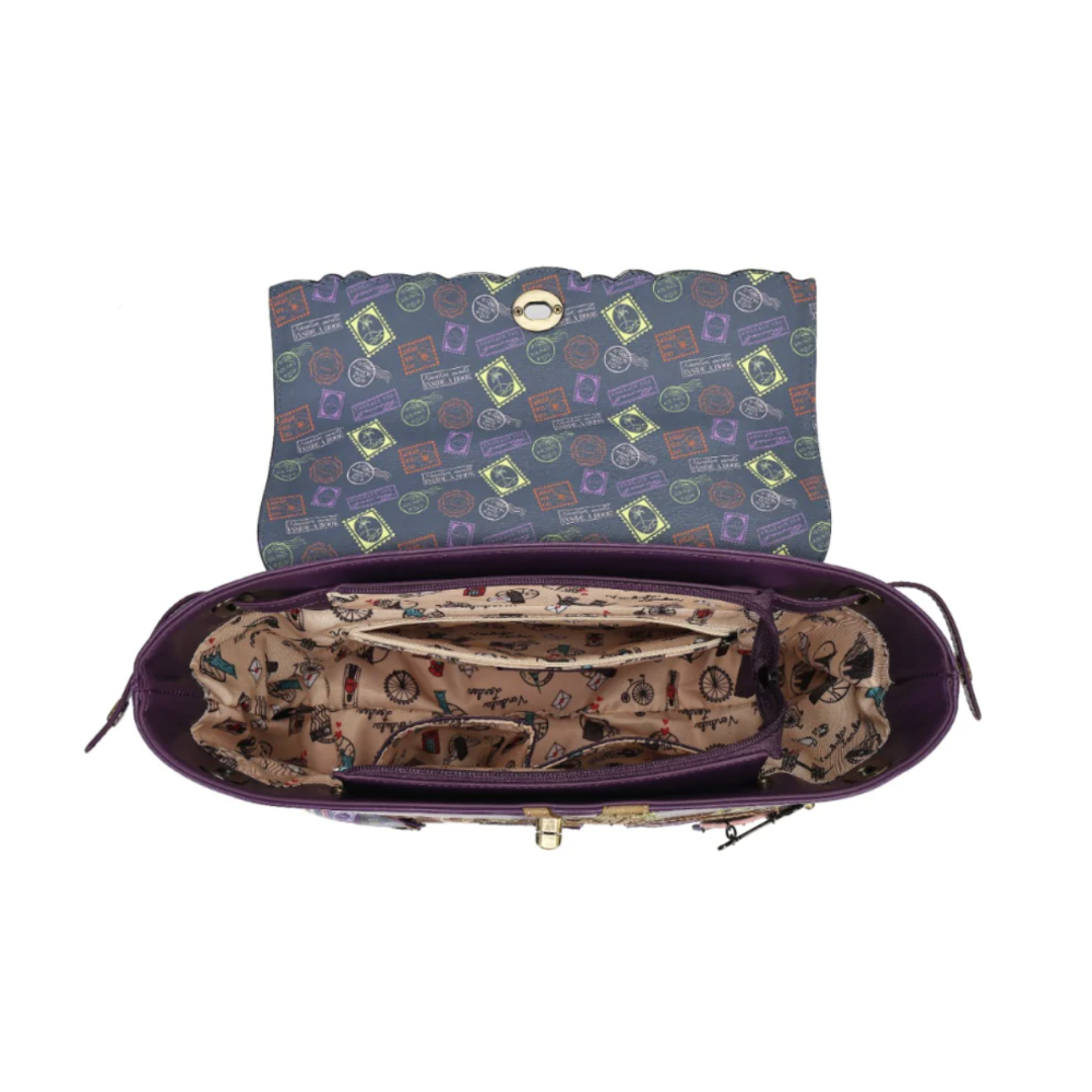 An open purple handbag shown from the inside, featuring a patterned interior lining and a patterned exterior flap in muted blue-gray, purple, and yellow tones, with gold-tone hardware on a white background.