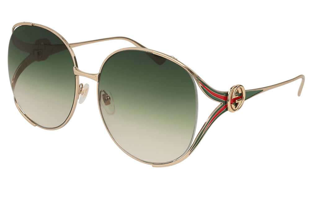 Gold-framed sunglasses with green gradient lenses on a white background