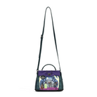 A structured handbag with a purple top flap, dark green textured leather sides, and a colorful illustrated front panel, featuring a long dark green shoulder strap on a white background.