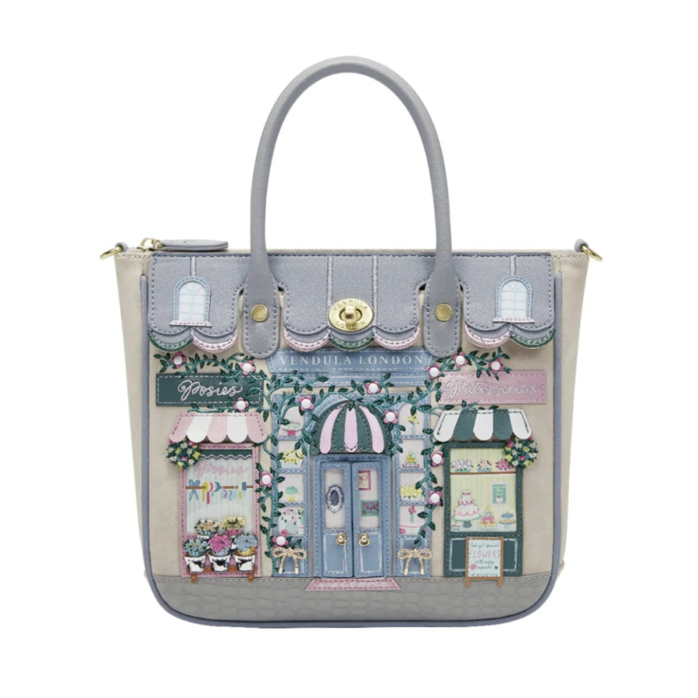 Handbag with a detailed design of a London street scene on a white background