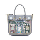 Handbag with a decorative design of shop fronts on a white background