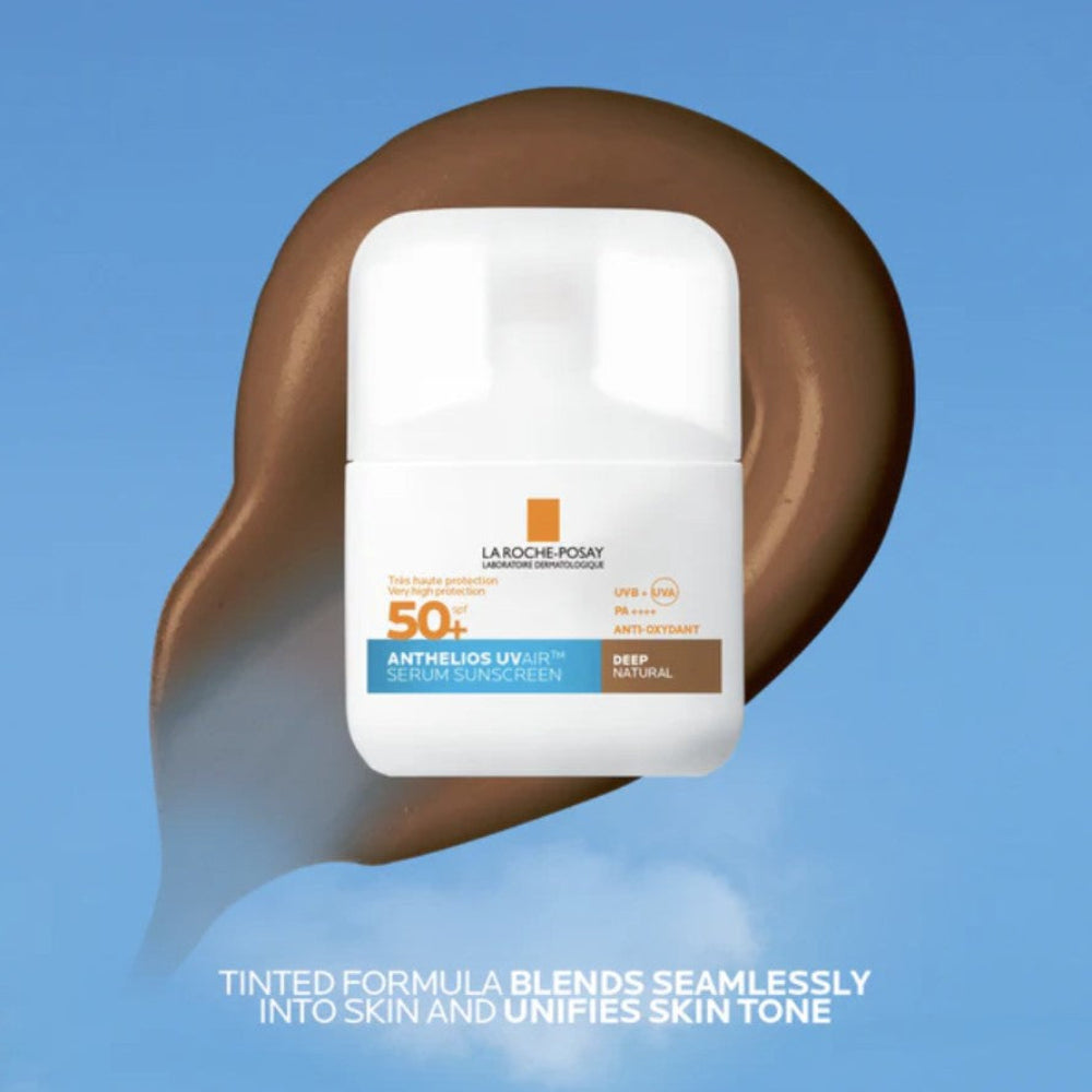 La Roche-Posay sunscreen bottle on a brown texture swatch background with blue sky.