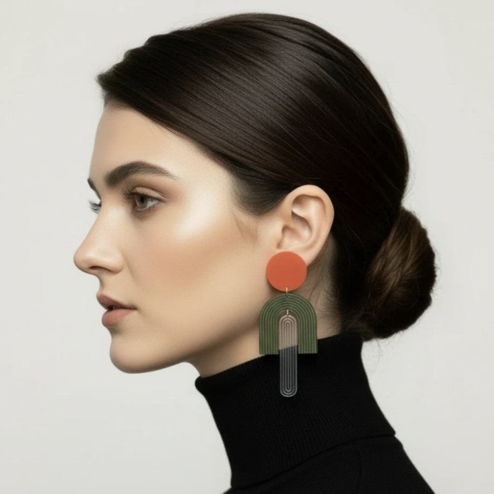 Woman wearing colorful earrings against a neutral background