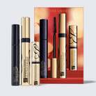 Estée Lauder makeup set featuring three cosmetic tubes and a matching red gift box on a light gray background. The set includes Little Black Primer in black packaging, Sumptuous Extreme in gold packaging