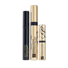 Three Estée Lauder cosmetic tubes arranged upright on a light gray background: a black tube labeled Little Black Primer, a tall gold tube labeled Sumptuous Extreme, and a smaller gold tube with a black band and monogram design.