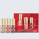 Estée Lauder lip oil set with red box on a light gray background