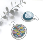 Two earrings with colorful designs on a white background