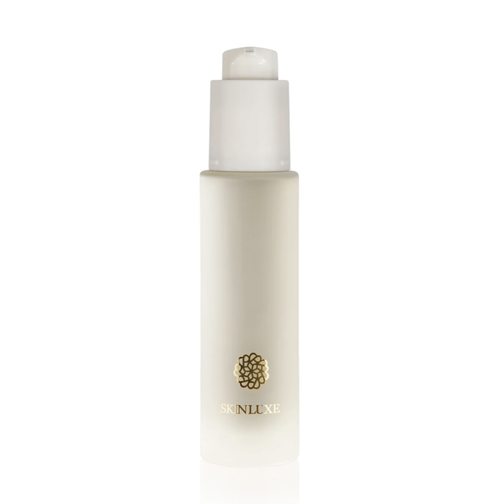 A frosted glass skincare bottle with a white pump dispenser and a small gold logo on the front, centered against a solid white background.