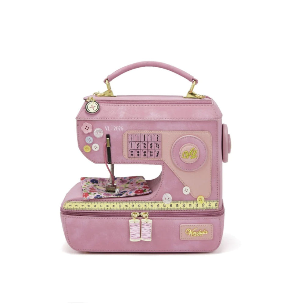 Pink sewing machine-shaped bag on a white background