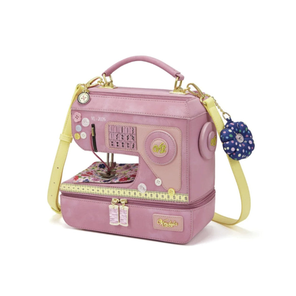 Pink sewing machine-shaped handbag with a yellow strap on a white background