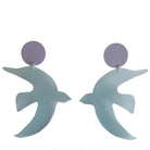 Pair of light blue bird-shaped earrings on a white background